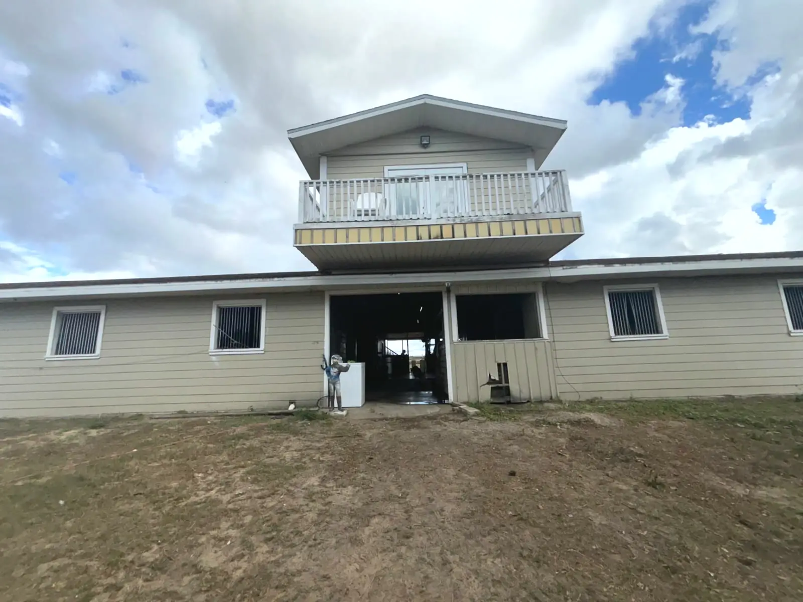 Lot 3 barn exterior with second-floor apartment and balcony