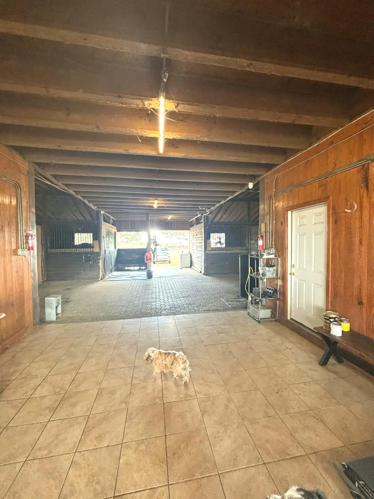 Tiled barn wing with tack room door and wash area